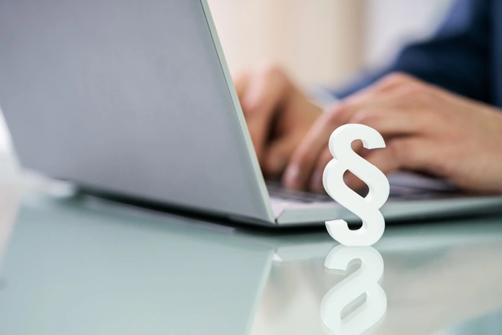 Laptop mit Paragraphen davor