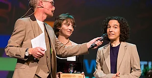 Westfalen Weser KulturStarter Preisverleihung. Zwei Frauen werden auf der Bühne der Verleihung zum KulturStarter von einem Mann interviewt.